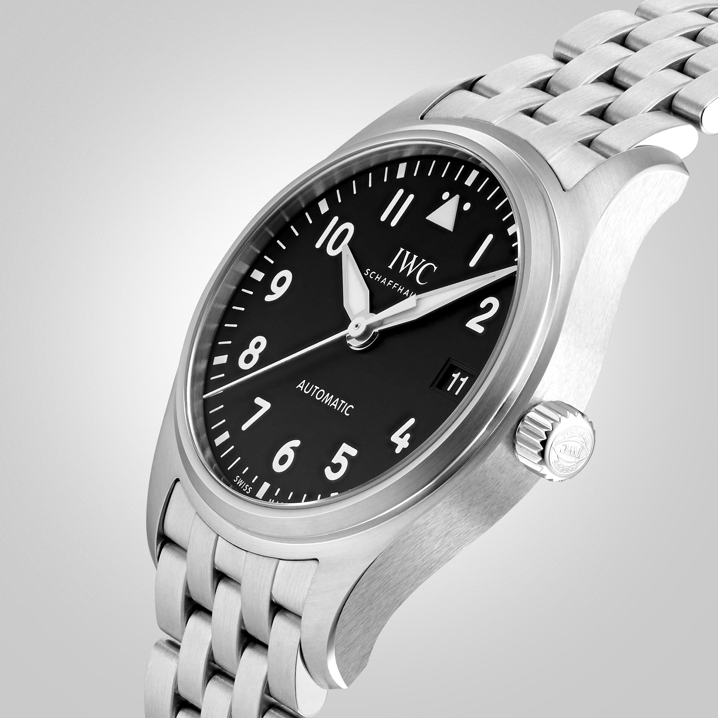 The IWC Schaffhausen Pilots Watch Automatic 36 features a stainless steel case, black dial with white numerals, Caliber 35111 movement, date at 3 o’clock, and a metal link bracelet.