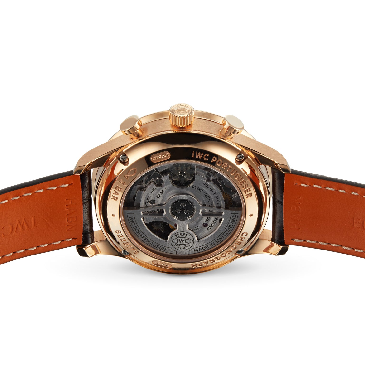 Close-up of the IWC Schaffhausen Portugieser Chronograph’s transparent case back reveals its intricate mechanical movement and leather strap—an elegant showcase of Swiss watchmaking.