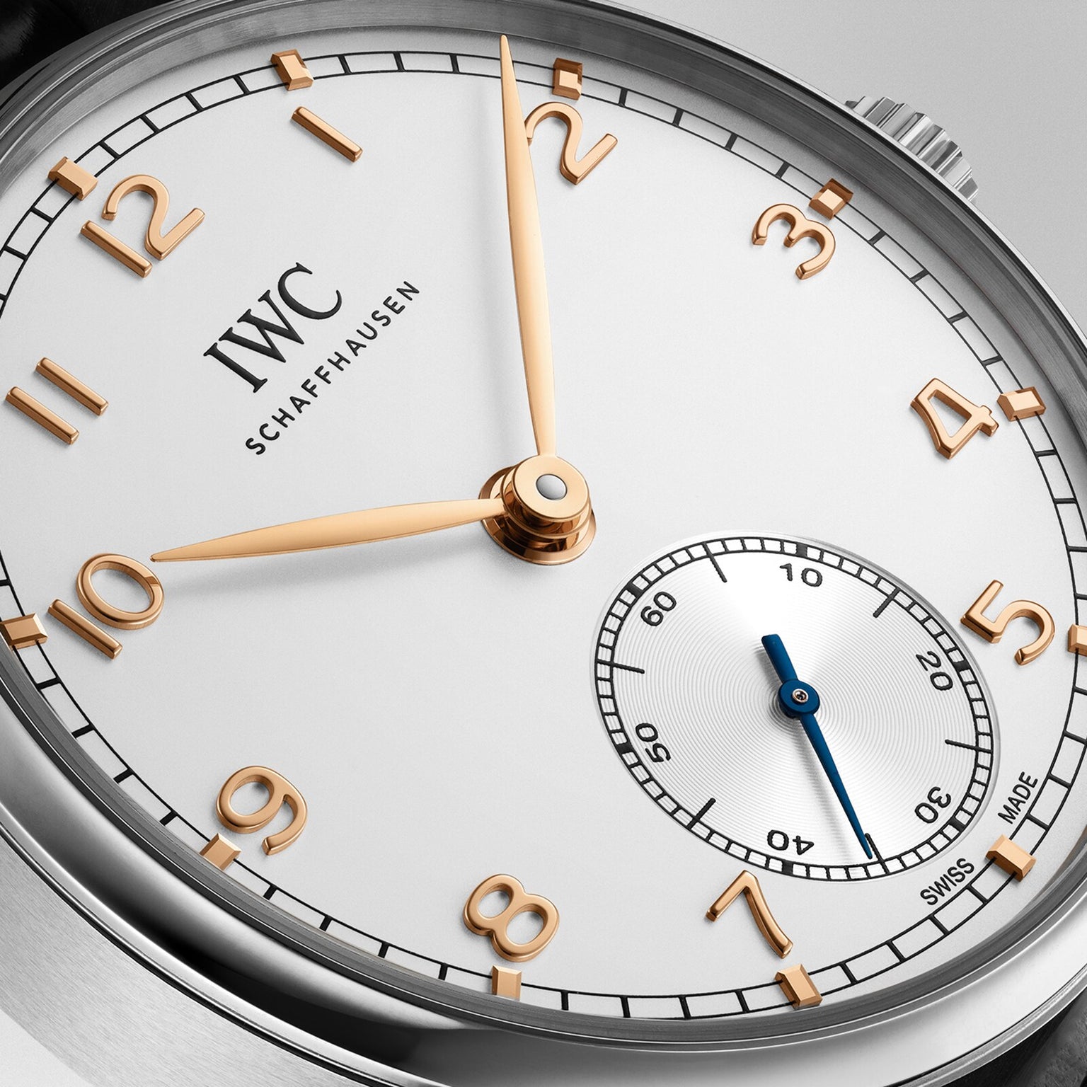 Close-up of the IWC Schaffhausen Portugieser Automatic 40 featuring gold hands, a white dial, and a small seconds subdial at 6 o’clock.