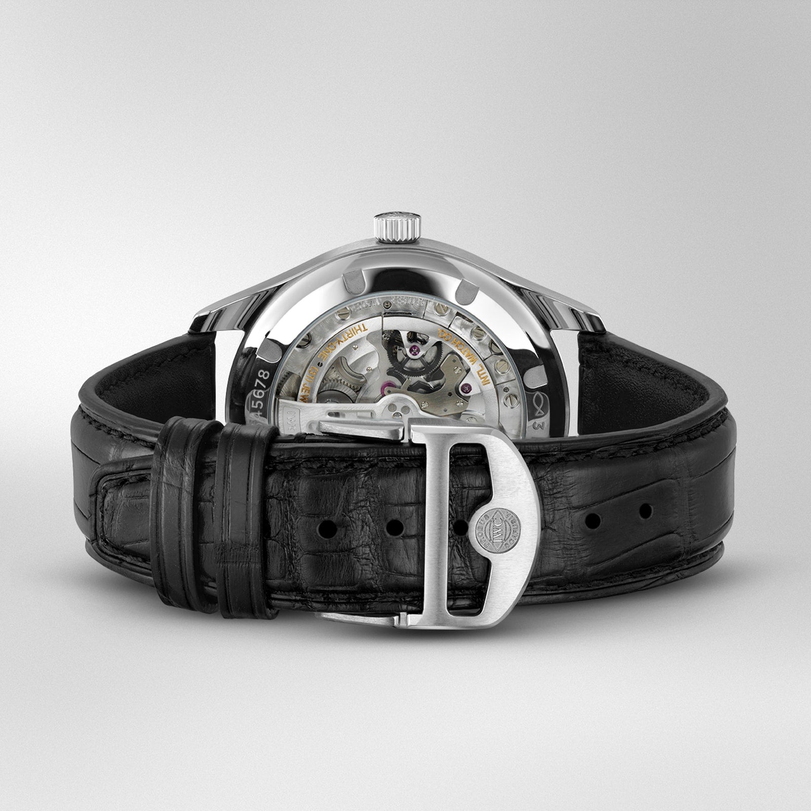 A close-up of the IWC Schaffhausen Portugieser Automatic 40 wristwatch with a black leather strap and visible mechanical movement, featuring a transparent case back.