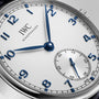 Close-up of an IWC Schaffhausen Portugieser Automatic 40 wristwatch featuring a white dial, blue hands and numerals, and a small seconds subdial at the 6 o’clock position.