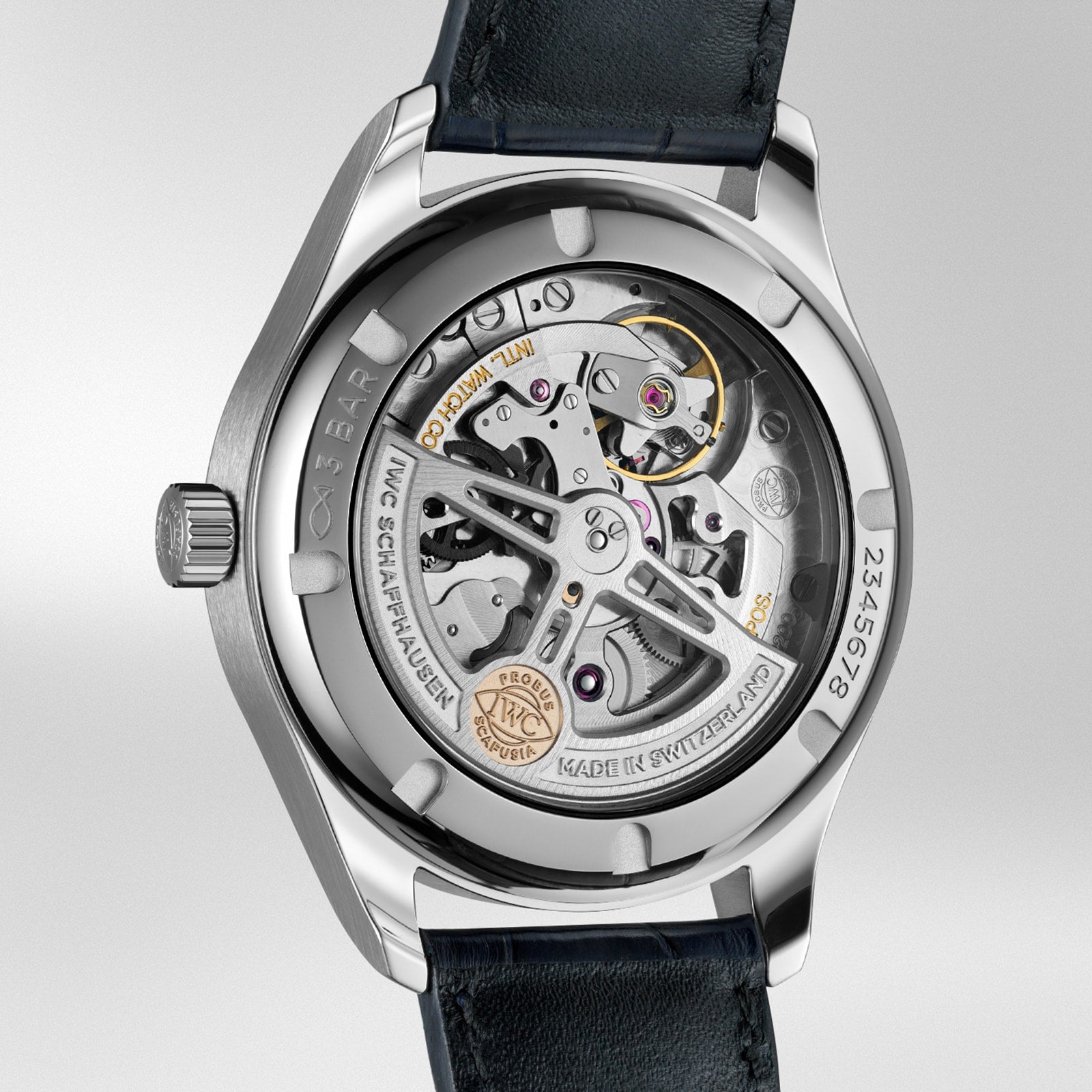 Close-up of the back of the Portugieser Automatic 40 by IWC Schaffhausen, highlighting its intricately labeled movement components and sleek black leather strap.