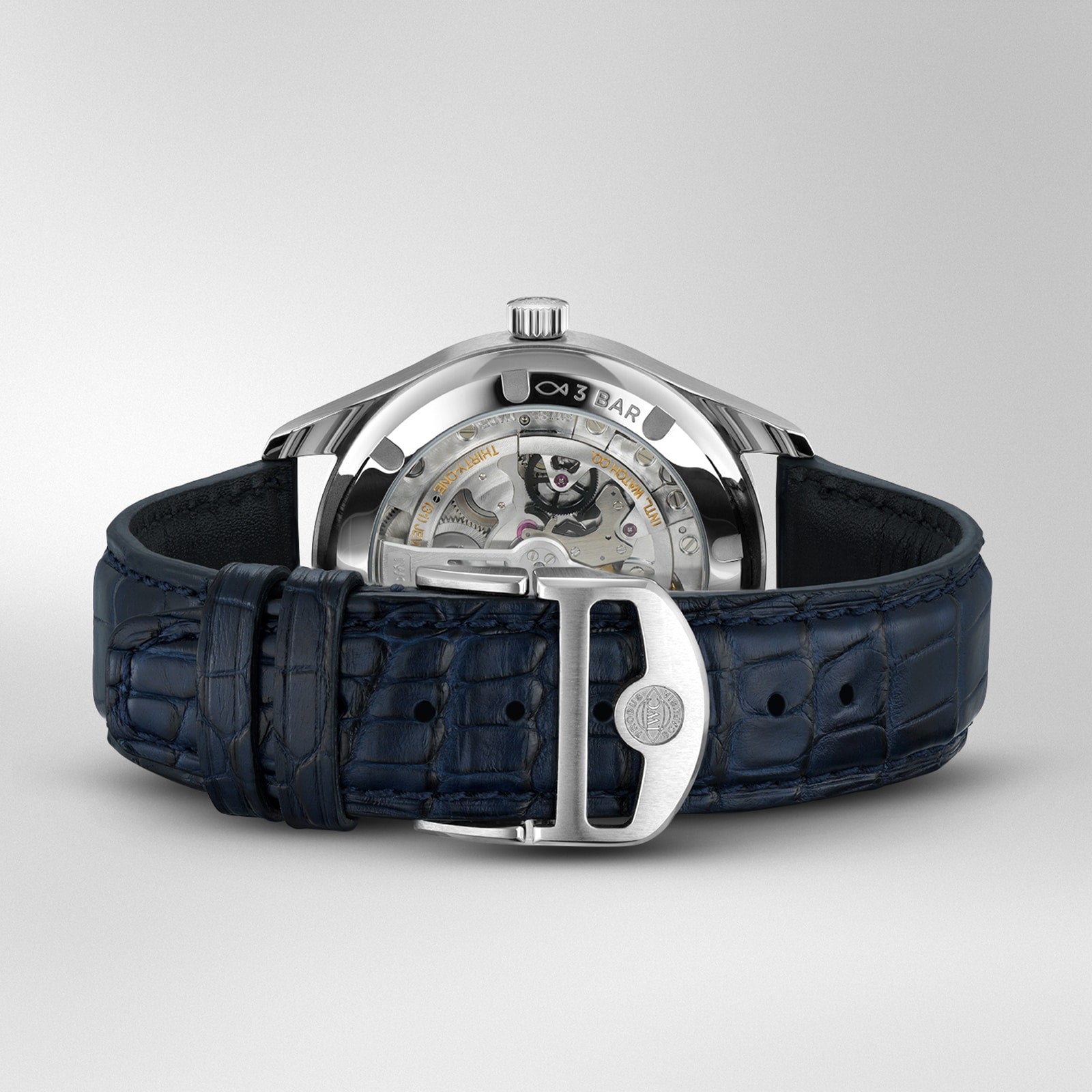 The IWC Schaffhausen Portugieser Automatic 40 features a blue leather strap and showcases its IWC-manufactured 82200 calibre movement through a transparent case back, set against a plain background.