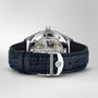 The IWC Schaffhausen Portugieser Automatic 40 features a blue leather strap and showcases its IWC-manufactured 82200 calibre movement through a transparent case back, set against a plain background.