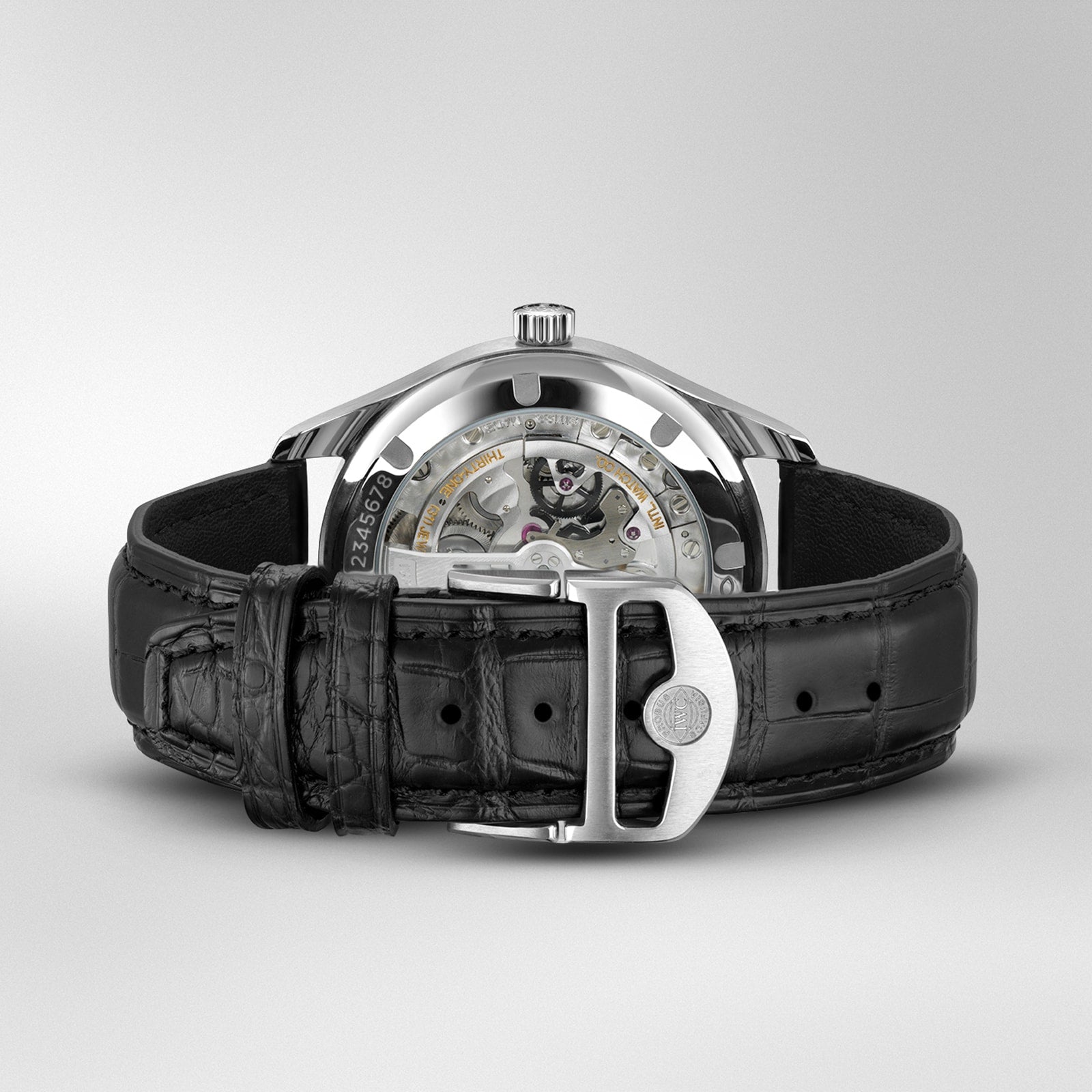 The IWC Schaffhausen Portugieser Automatic 40 showcases its visible 82200 calibre movement with Pellaton winding, black leather strap, and stainless steel buckle—viewable from the back for a touch of luxury.