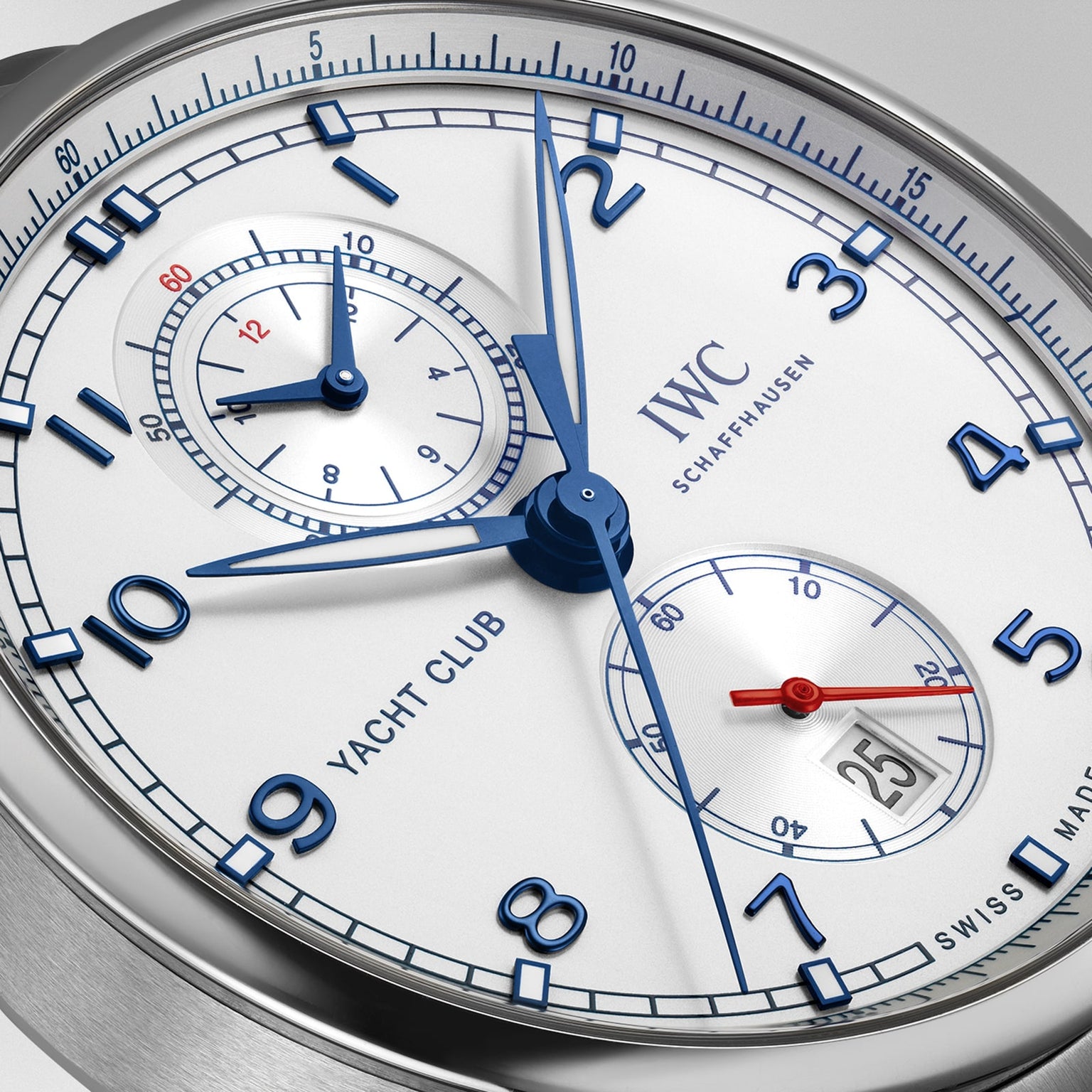 Close-up of an IWC Schaffhausen Portugieser Yacht Club Chronograph watch, featuring blue hands, blue numerals, subdials, and a date window showing 25—a refined nautical sports timepiece.