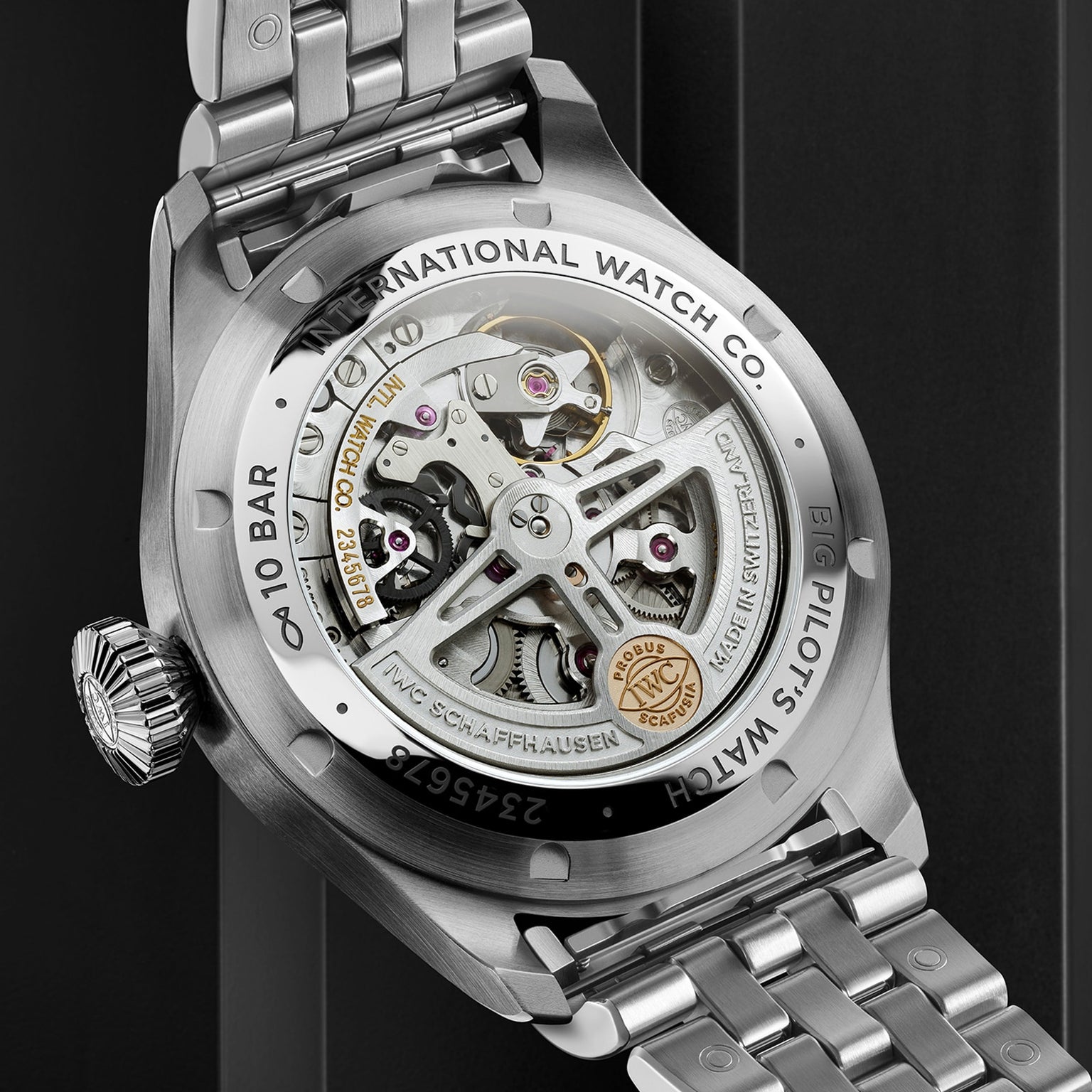 Close-up of the Big Pilots Watch 43 by IWC Schaffhausen, revealing its in-house calibre and detailed engravings through a transparent case back within a sturdy stainless steel case.