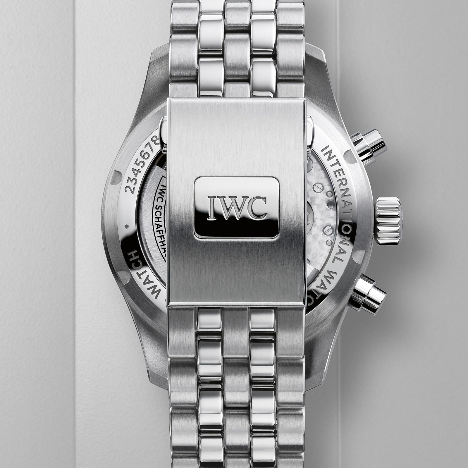 Close-up of the back of an IWC Schaffhausen Pilots Watch Chronograph 41, highlighting its stainless steel bracelet, clasp with engraved IWC logo, and a glimpse of the watch’s mechanical movement from the iconic collection.