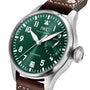 A close-up of an IWC Schaffhausen Big Pilots Watch featuring a green dial with white numerals, date display, 7-day power reserve indicator, and a brown leather strap.