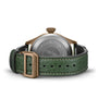 The IWC Schaffhausen Big Pilots Watch 43 Spitfire is shown from the back with a green leather strap, bronze buckle, engraved airplane motif, INTERNATIONAL WATCH CO. text, and EasX-CHANGE system compatibility.