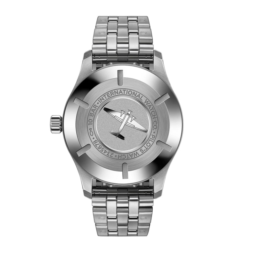 A silver wristwatch with a metal link bracelet, displayed from the back, shows engraved IWC Schaffhausen branding and a propeller logo on the case back—an iconic detail of the Pilots Watch Mark XX.