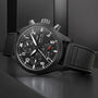 Black wristwatch with detailed face on a dark background