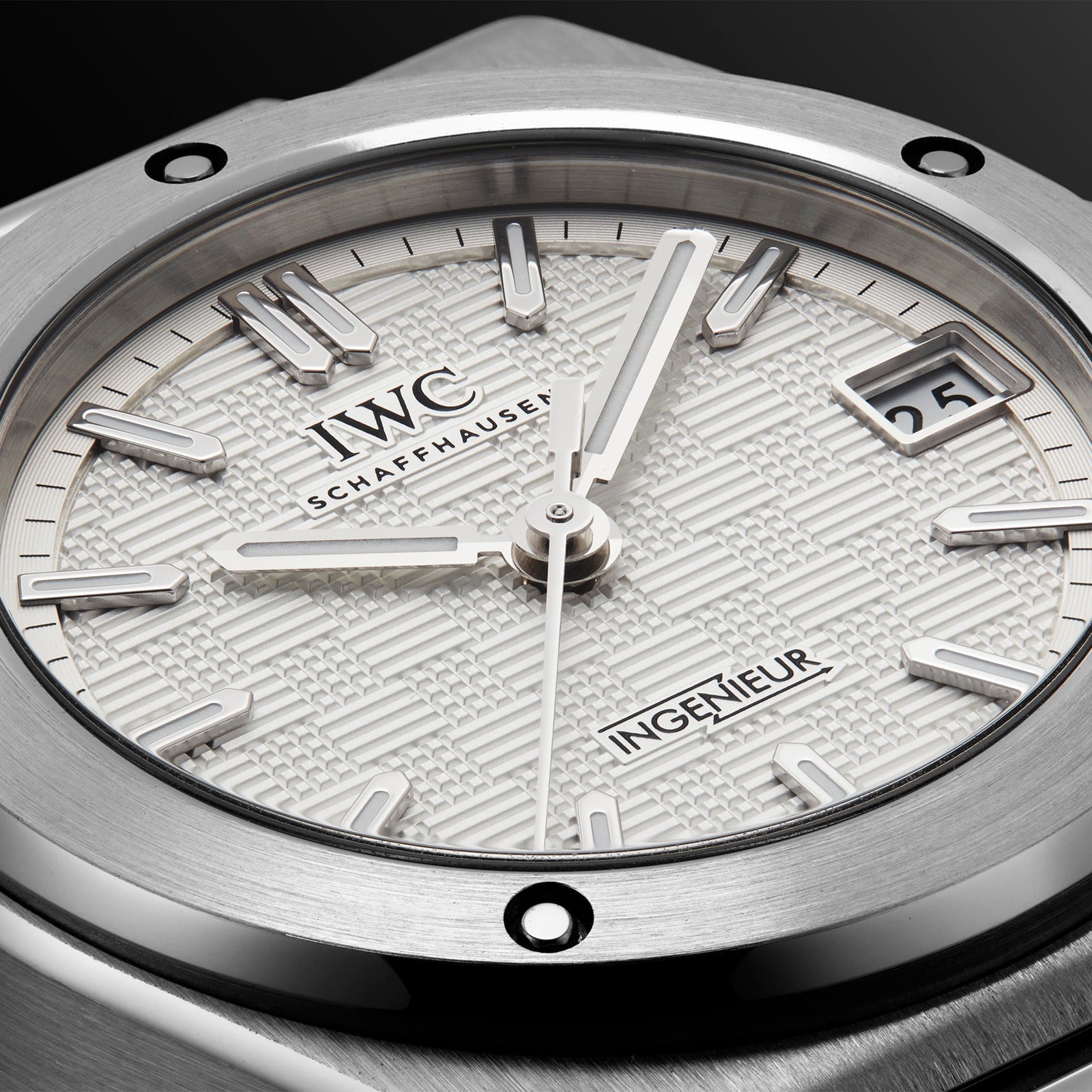 Close-up of the IWC Schaffhausen Ingenieur Automatic 35, featuring a textured white dial, silver markers and hands, plus a date window at 3 o’clock—an iconic timepiece inspired by Gérald Genta.