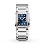 The Patek Philippe Twenty~4 4910/1200A-001 is a silver rectangular wristwatch featuring a blue face and diamond accents on the sides of the case.