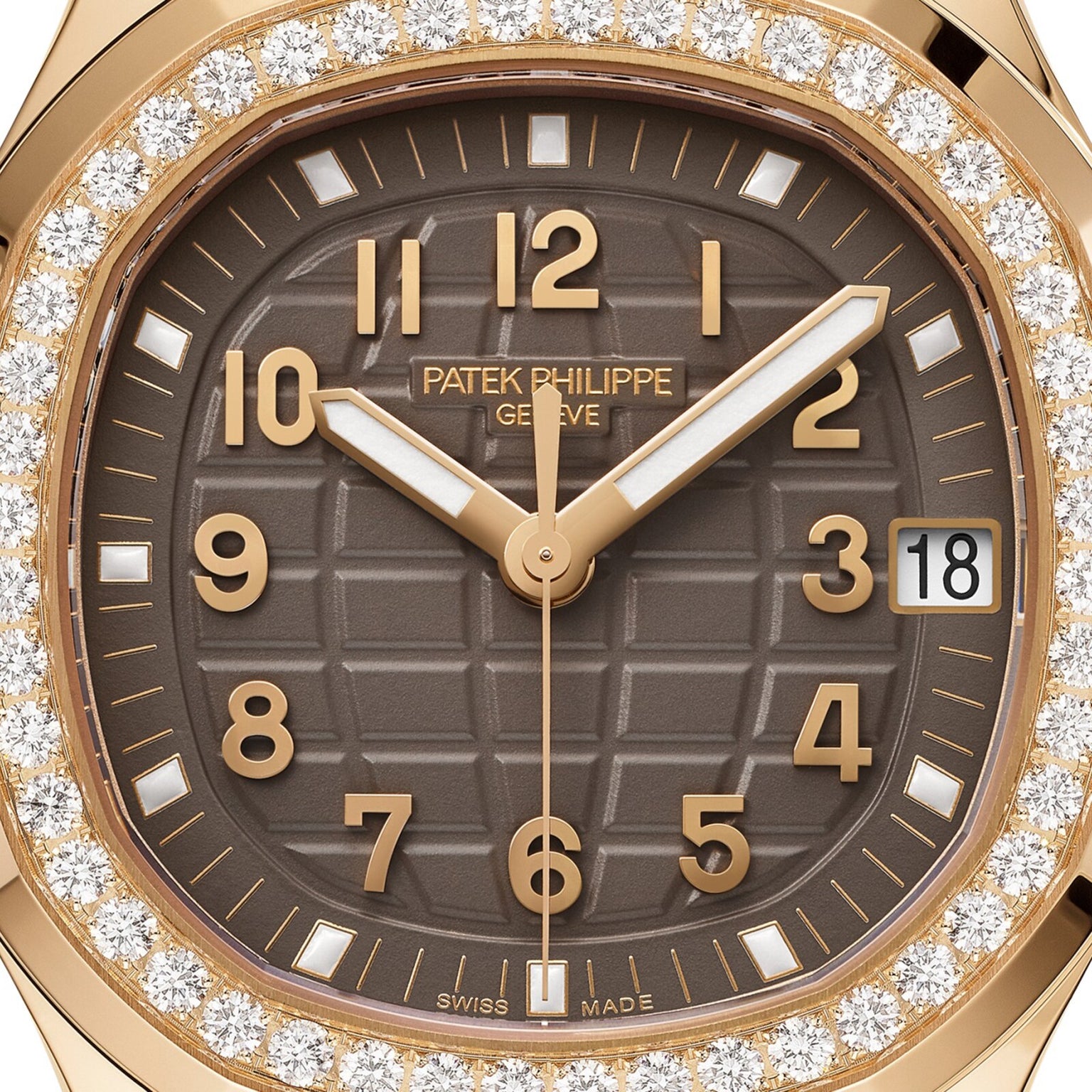 Close-up of a Patek Philippe Aquanaut 5268/200R-010 watch with a brown face, gold hands, and a diamond bezel, displaying the date as 18.