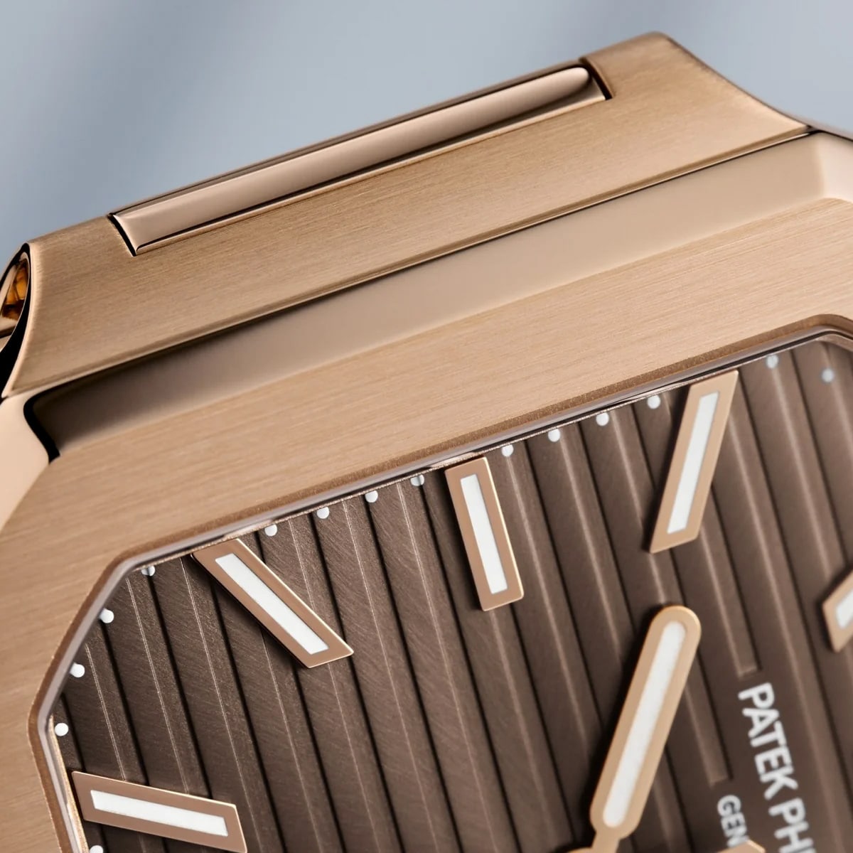 Close-up of the Patek Philippe Cubitus 7128/1R-001 watch featuring a brown dial with white-gold hour markers.