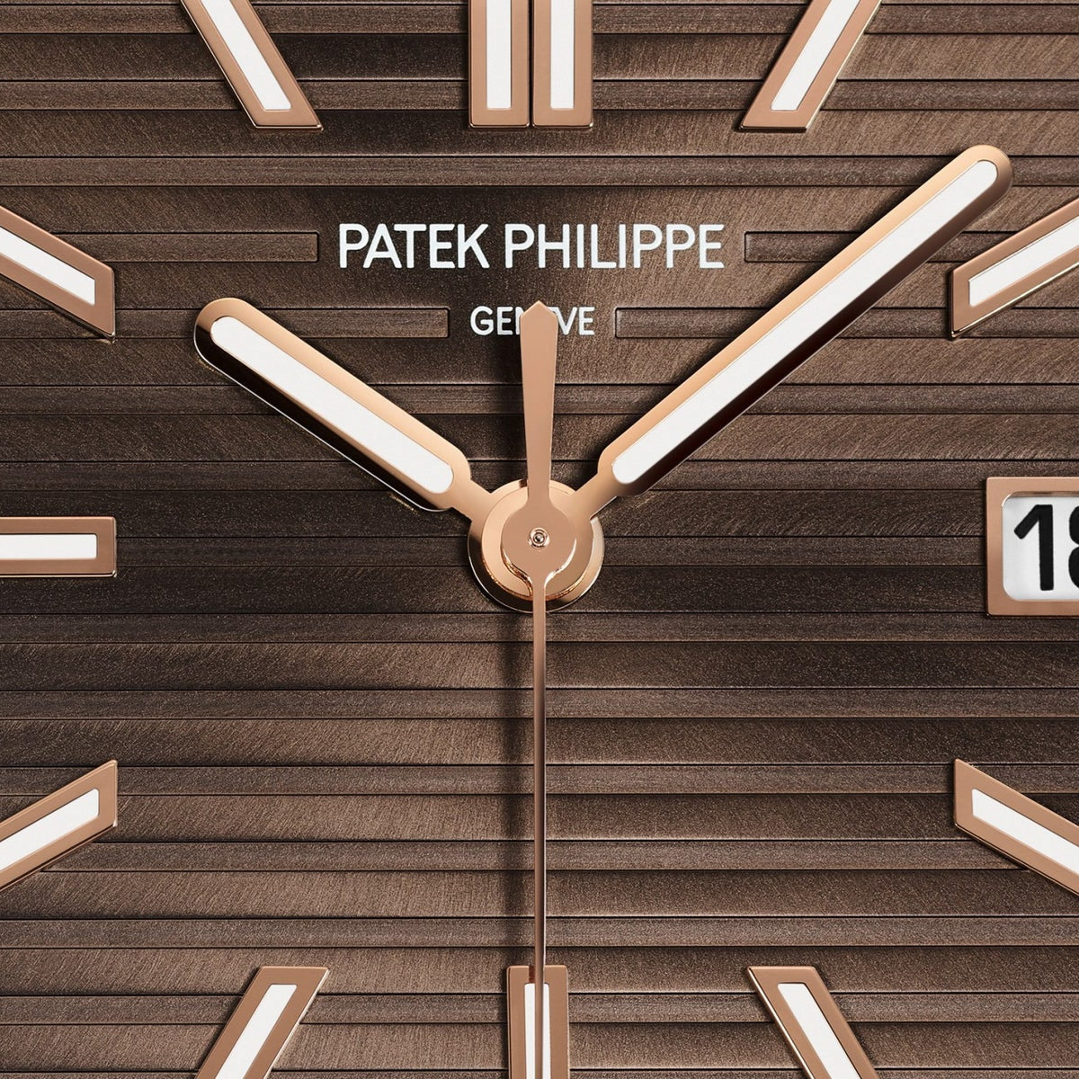Close-up of the Patek Philippe Cubitus 7128/1R-001 watch face in brown with gold hands, white markers, and date display.