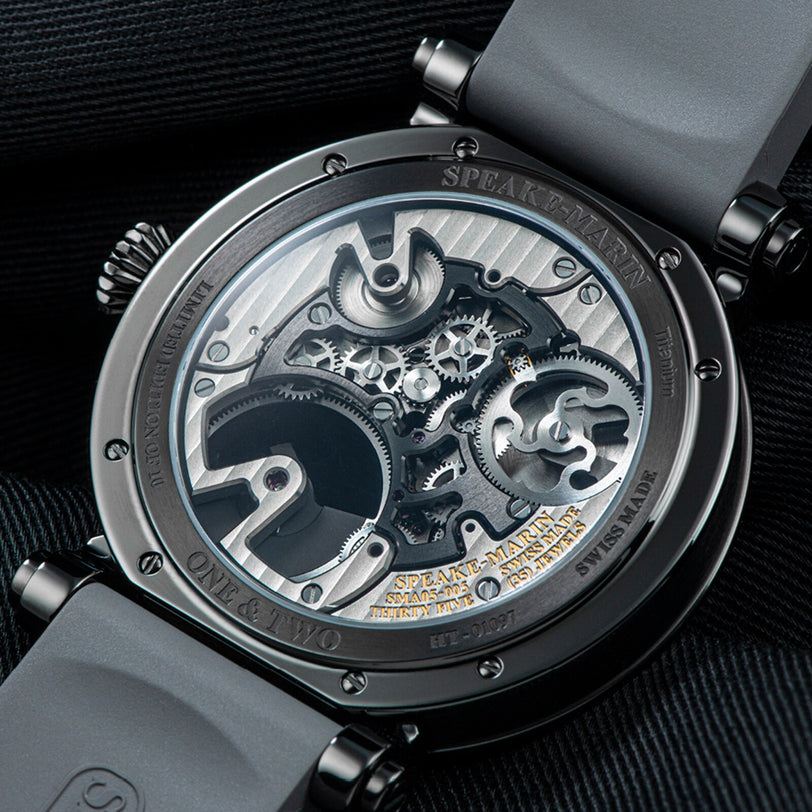 Close-up of the Speake Marin Openworked Tourbillon Black DLC’s transparent case back showcasing its intricate gears and mechanical movement.