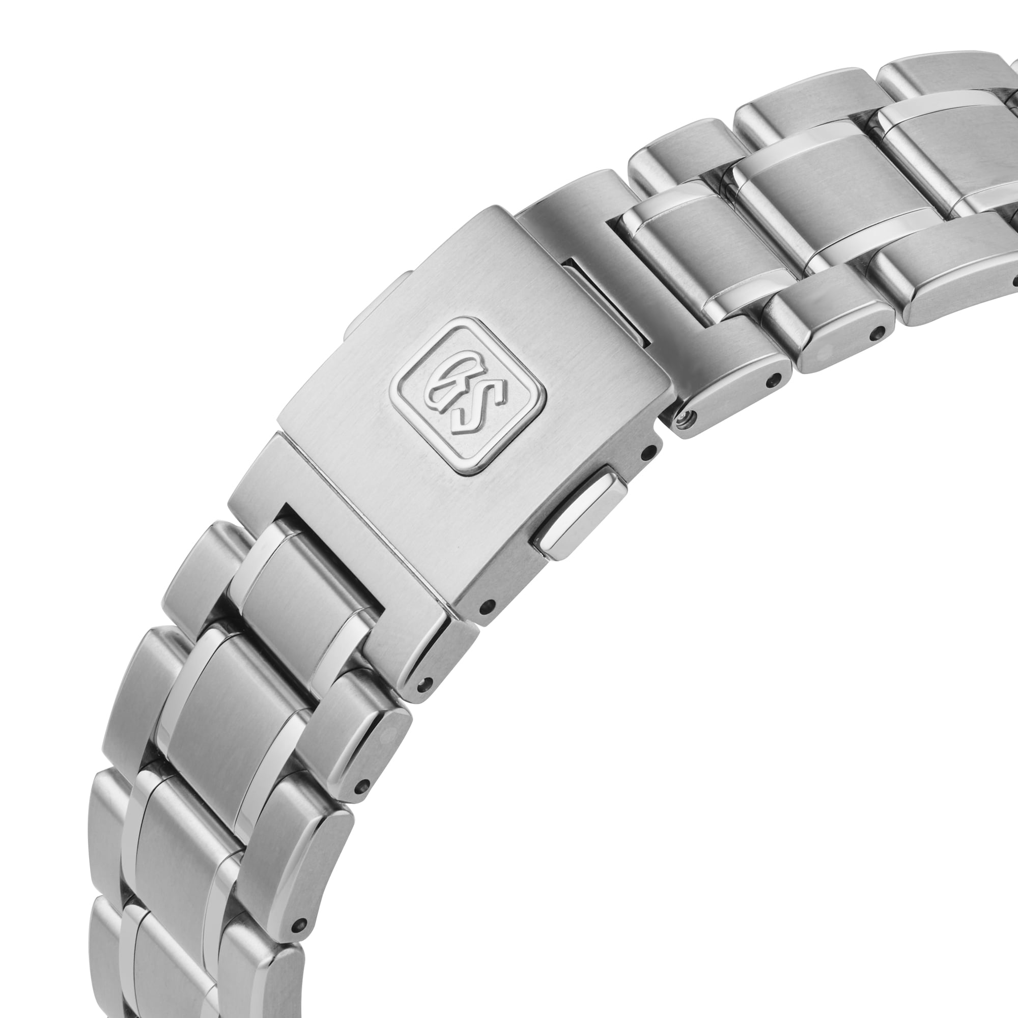 Close-up of the Grand Seiko Spring Drive Heritage stainless steel bracelet with a clasp engraved with the GS logo.