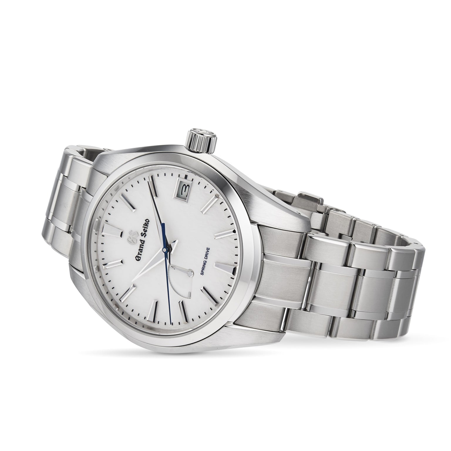 The Grand Seiko Spring Drive Heritage is a silver wristwatch with a white dial, silver hour markers, a date window at 3 o’clock, and a stainless steel bracelet, featuring the acclaimed Spring Drive movement for superior accuracy.