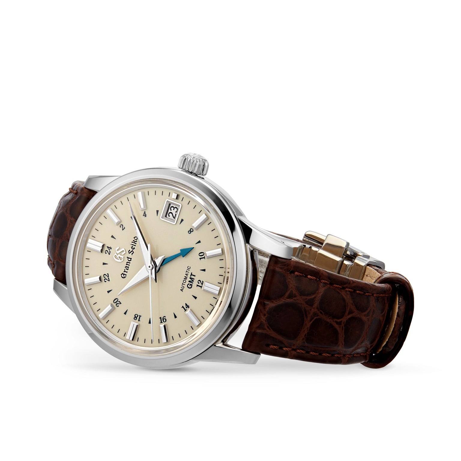 The Grand Seiko Automatic GMT Elegance watch features a cream dial, silver markers, blue GMT hand, date window, and brown leather strap with automatic movement, shown against a white background.