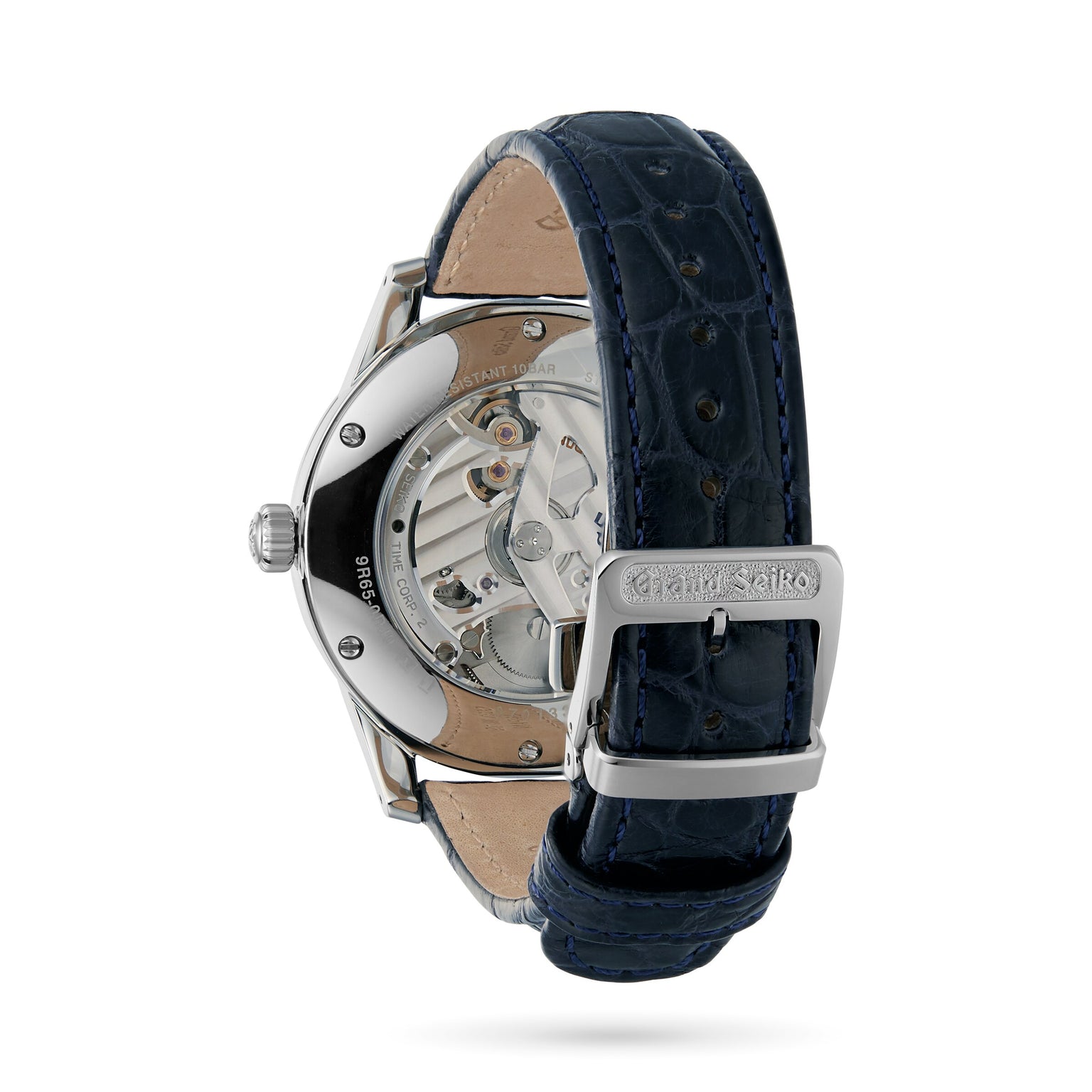 A close-up of the Grand Seiko Spring Drive Elegance showing its stainless steel case, transparent back displaying the movement, and a dark blue leather strap with metal buckle.