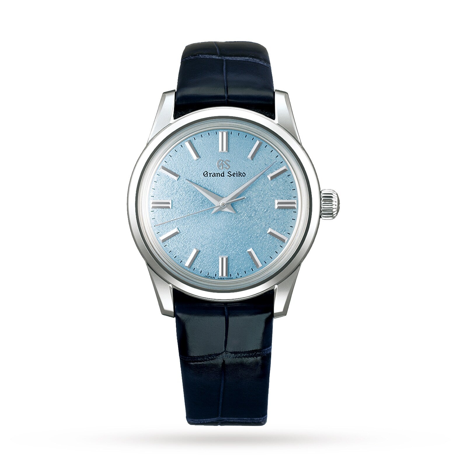 The Grand Seiko Manual Elegance is a silver mechanical watch with a light blue textured dial, silver hour markers, and a dark blue leather strap, powered by the precise Caliber 9S64 movement and shown against a white background.