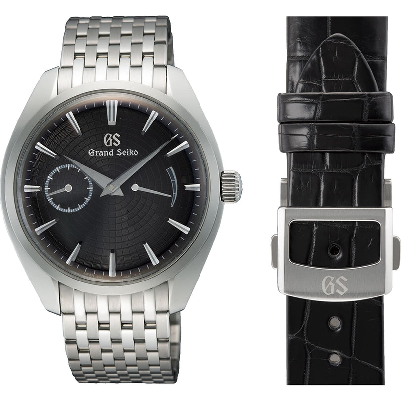 The Grand Seiko Manual Elegance wristwatch features a black textured dial, metal bracelet, and Zaratsu craftsmanship, displayed beside a black leather strap with a metal GS-engraved clasp.