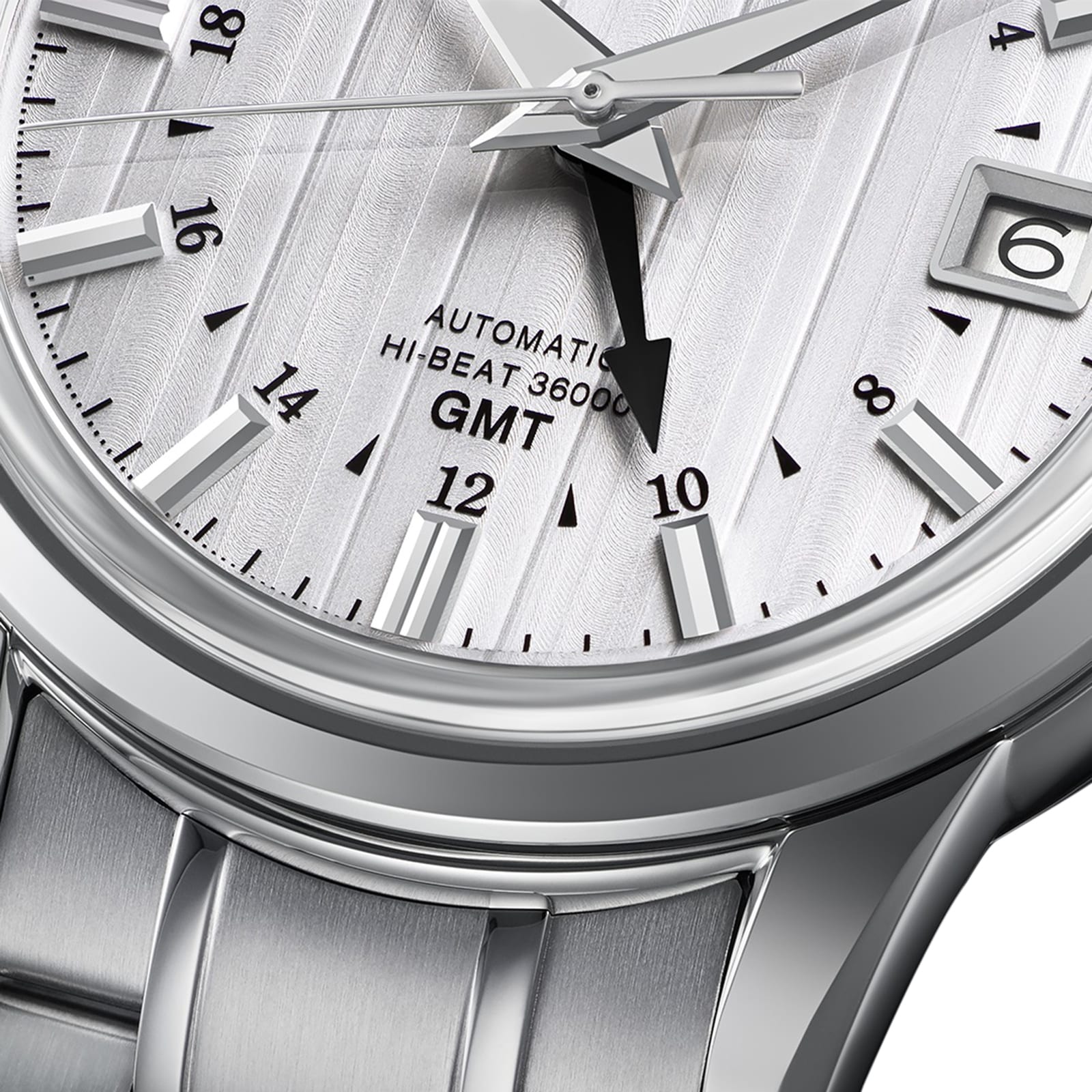 Close-up of the Grand Seiko Hi-Beat GMT Elegance wristwatch, showcasing its textured dial with time, date, and GMT features, plus Automatic Hi-Beat 36000 text and a sleek metal bracelet.