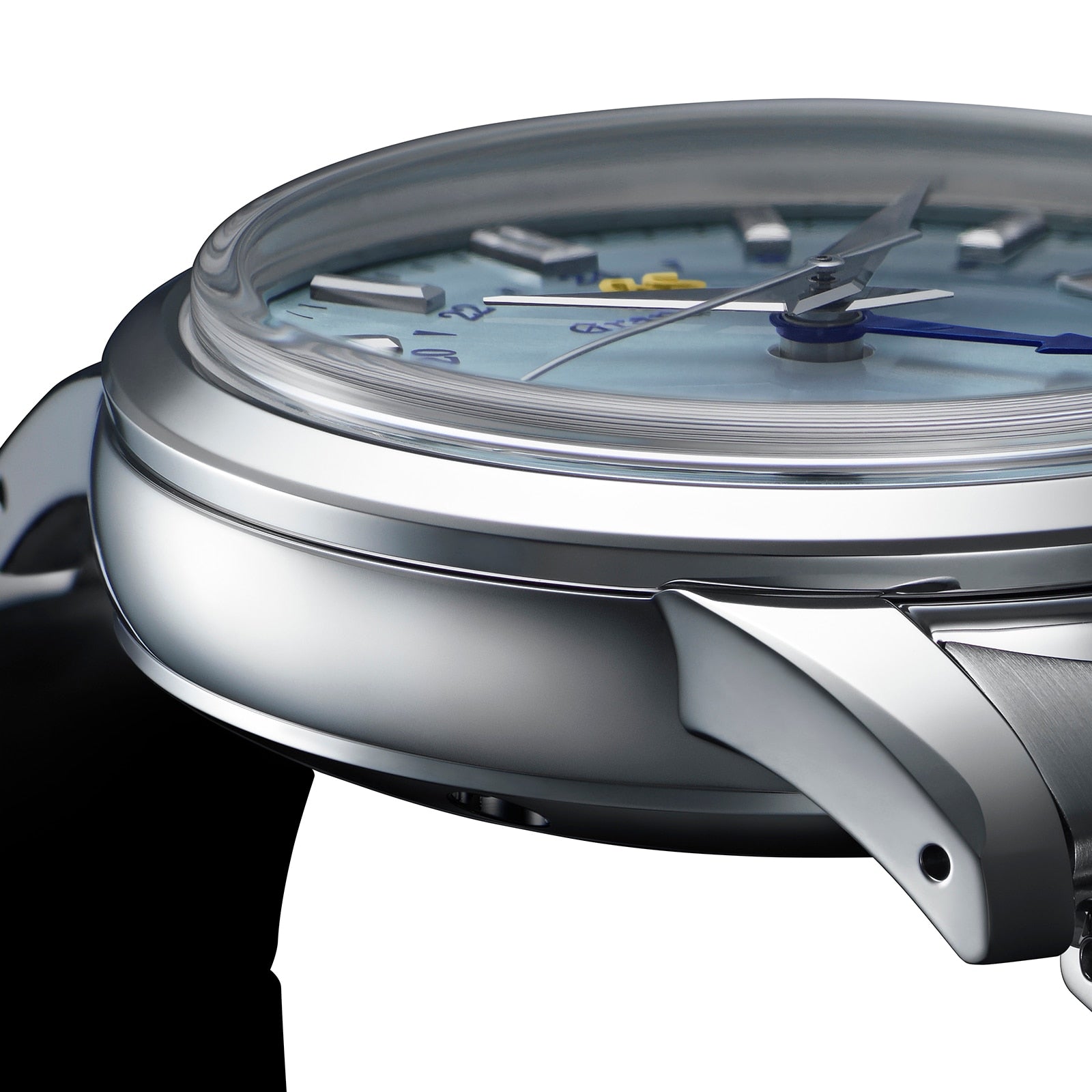 Close-up side view of the Grand Seiko Automatic GMT Elegance, featuring a silver case, visible crown, blue hands, detailed watch face, curved crystal, and Calibre 9S66 movement.