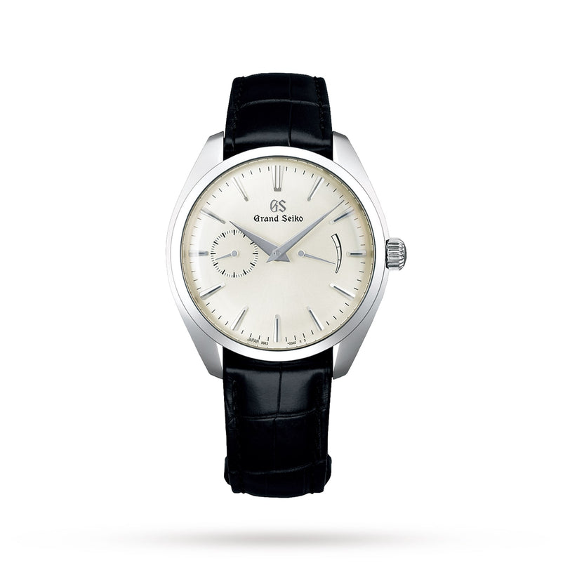 The Grand Seiko Manual Elegance wristwatch features a silver dial, black leather strap, simple index markers, and a small seconds sub-dial at 8 o’clock, powered by the manual Calibre 9S63 and displayed on a white background.