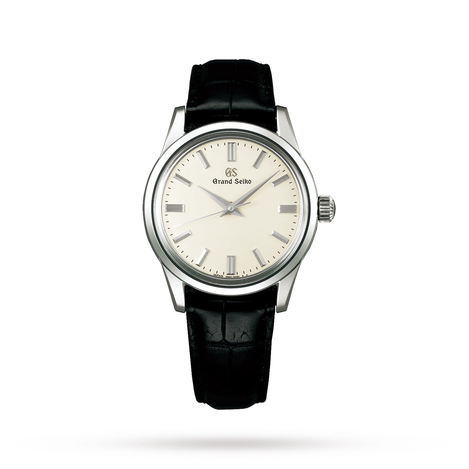 The Grand Seiko Manual Elegance wristwatch features a silver dial, silver markers, and a black leather strap, with an exhibition case back displaying its advanced hairspring technology, shown on a white background.