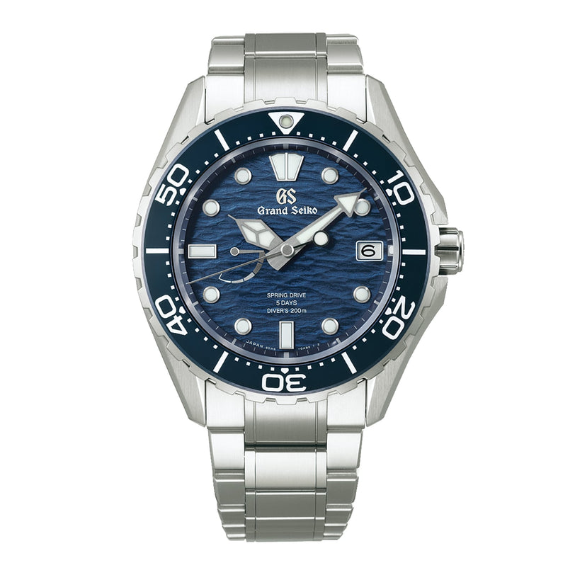 The Grand Seiko Spring Drive 5 Days Evolution 9 dive watch features a blue wave-patterned dial, silver hour markers, a date window at 3 o’clock, and a durable high-intensity titanium bracelet.