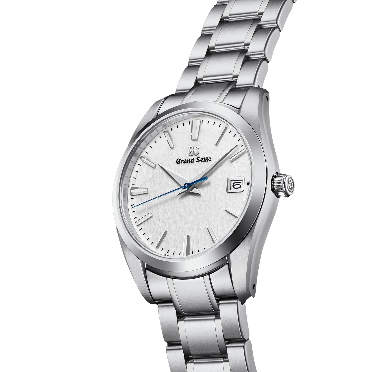 The Grand Seiko Quartz Heritage features a 37mm titanium case, snowflake dial, blue second hand, date window at 3 o’clock, and a stainless steel link bracelet.