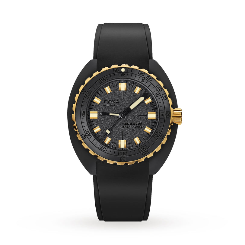 The DOXA Sub 300 Beta Sharkhunter is a black and gold wristwatch with a textured black dial, gold markers, a black rubber strap, and shows the time at 10:10.