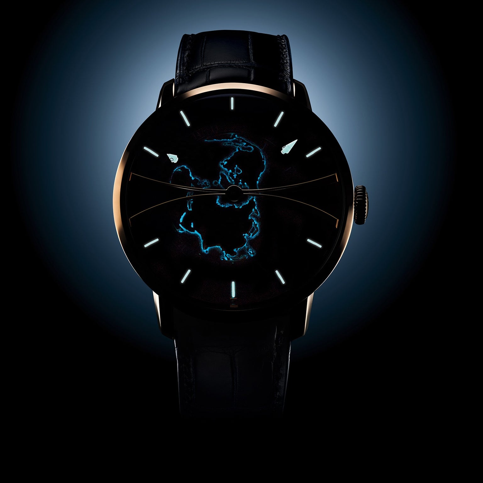 The Arnold & Son Globetrotter Red Gold features a dark dial with a luminous blue outline of Antarctica and minimal hour markers.