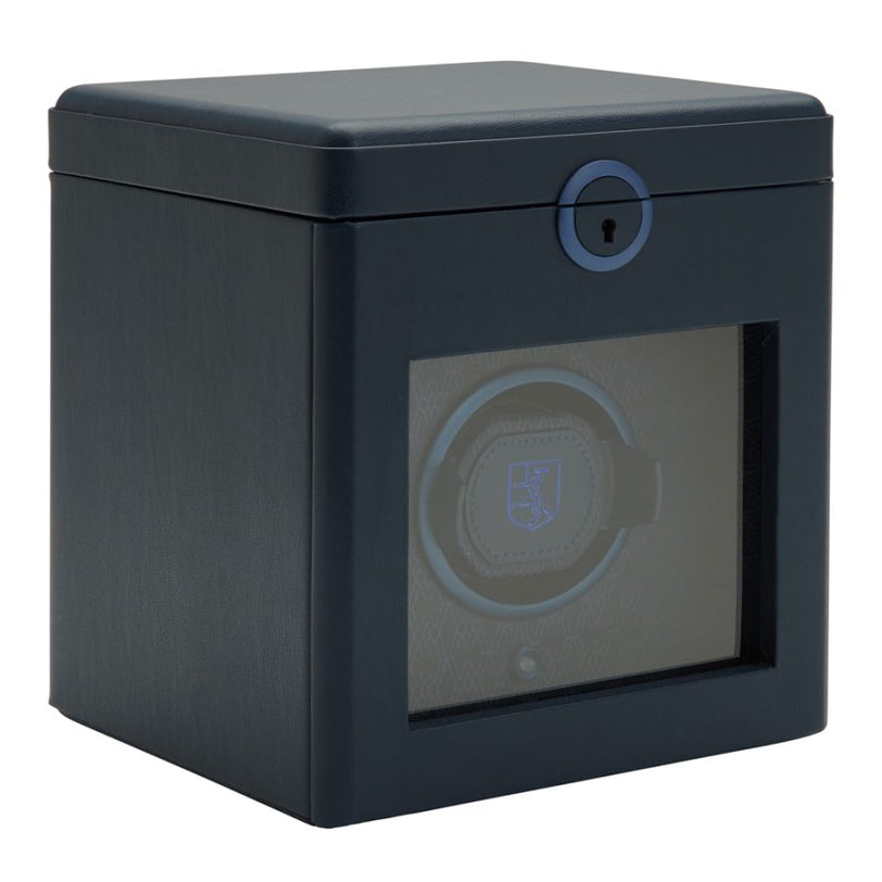 Black cubic watch winder with padded top, front window display, blue accent lock, and single watch cushion visible inside.