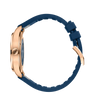 Rose gold pilot's watch with blue dial and navy blue rubber strap, shown from the side.