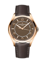 Rose gold-tone watch with brown dial, Arabic numerals, date window, and dark leather strap with contrast stitching.