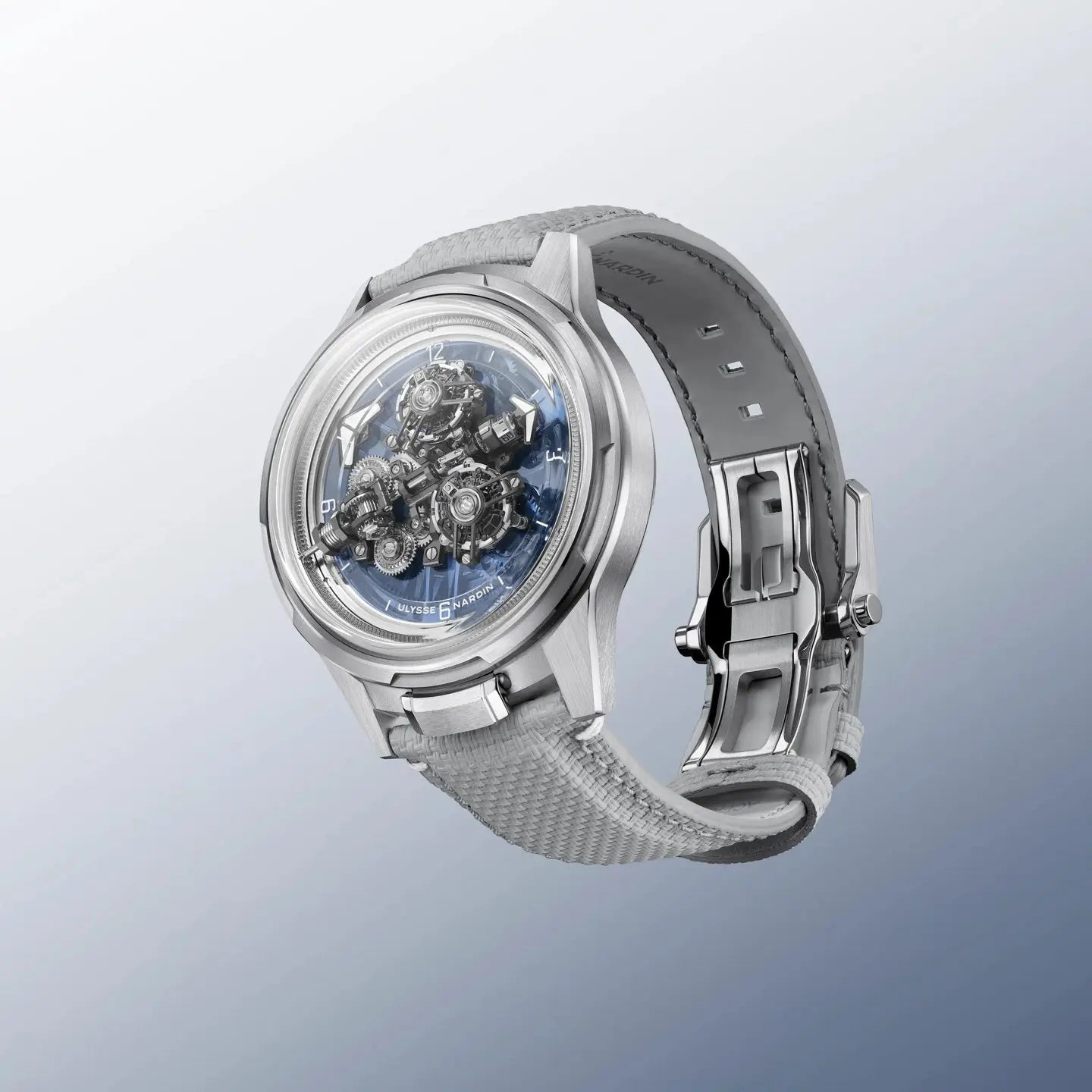 Silver wristwatch with intricate design on a light gray background