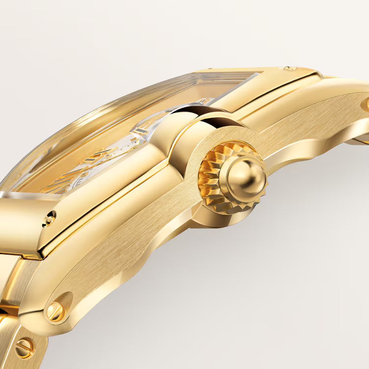 Gold-toned model car with streamlined body, detailed wheels, and windshield shown from side angle.