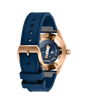Rose gold pilot watch with dark blue dial featuring Le Petit Prince illustration, blue rubber strap, and visible caseback sho