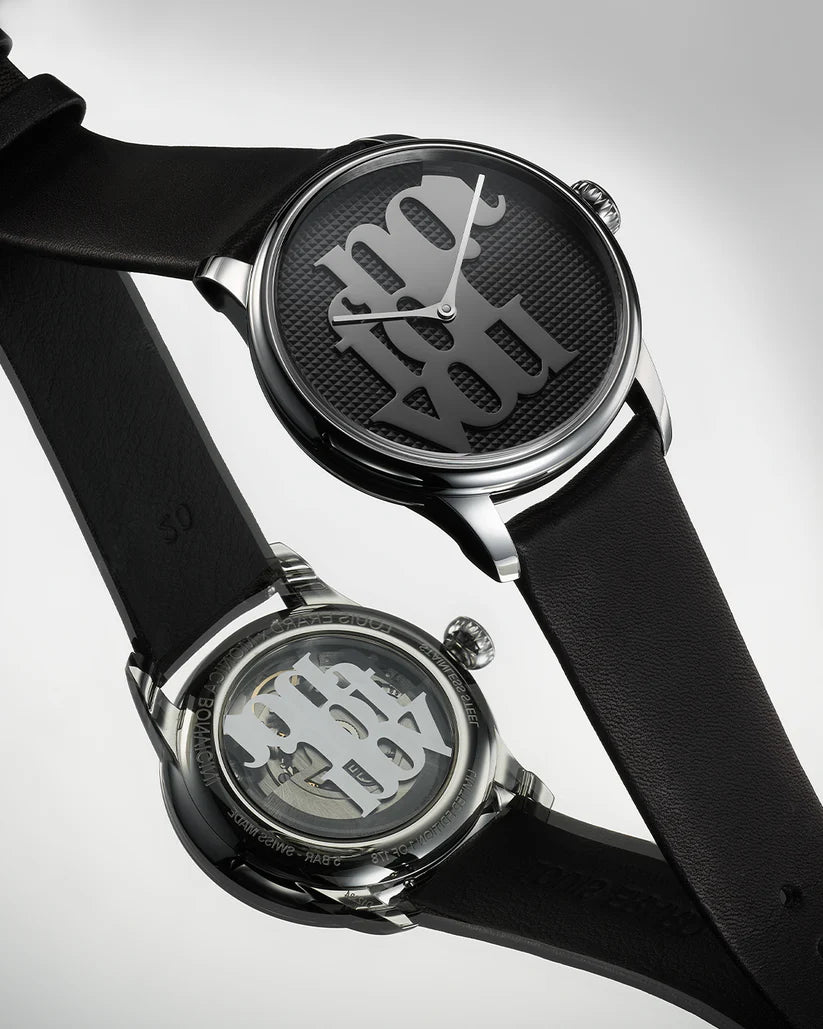 Black watch with a unique face design on a light gray background