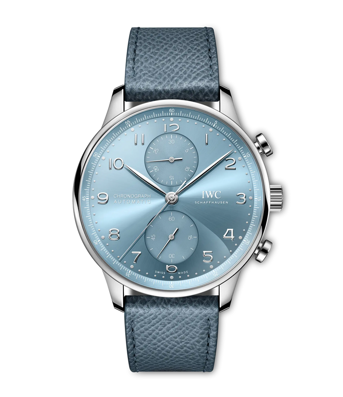 The IWC Schaffhausen Portugieser Chronograph showcases a light blue dial with three subdials, silver markers and hands, and a textured blue leather strap, complemented by two pushers and a crown on the right side.