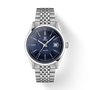 Tissot Visodate stainless steel watch with dark blue dial, date window, and matching metal bracelet.