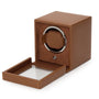 The WOLF Cub Single Watch Winder with Cover features a brown leather design and an open glass door, revealing the interior watch holder.