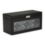 The WOLF Classic Triple Watch Winder with Storage is a black rectangular box featuring a glass front that displays three watch holders inside.