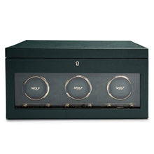 The WOLF British Racing Triple Watch Winder with Storage is a green box featuring a glass front and three circular compartments inside.
