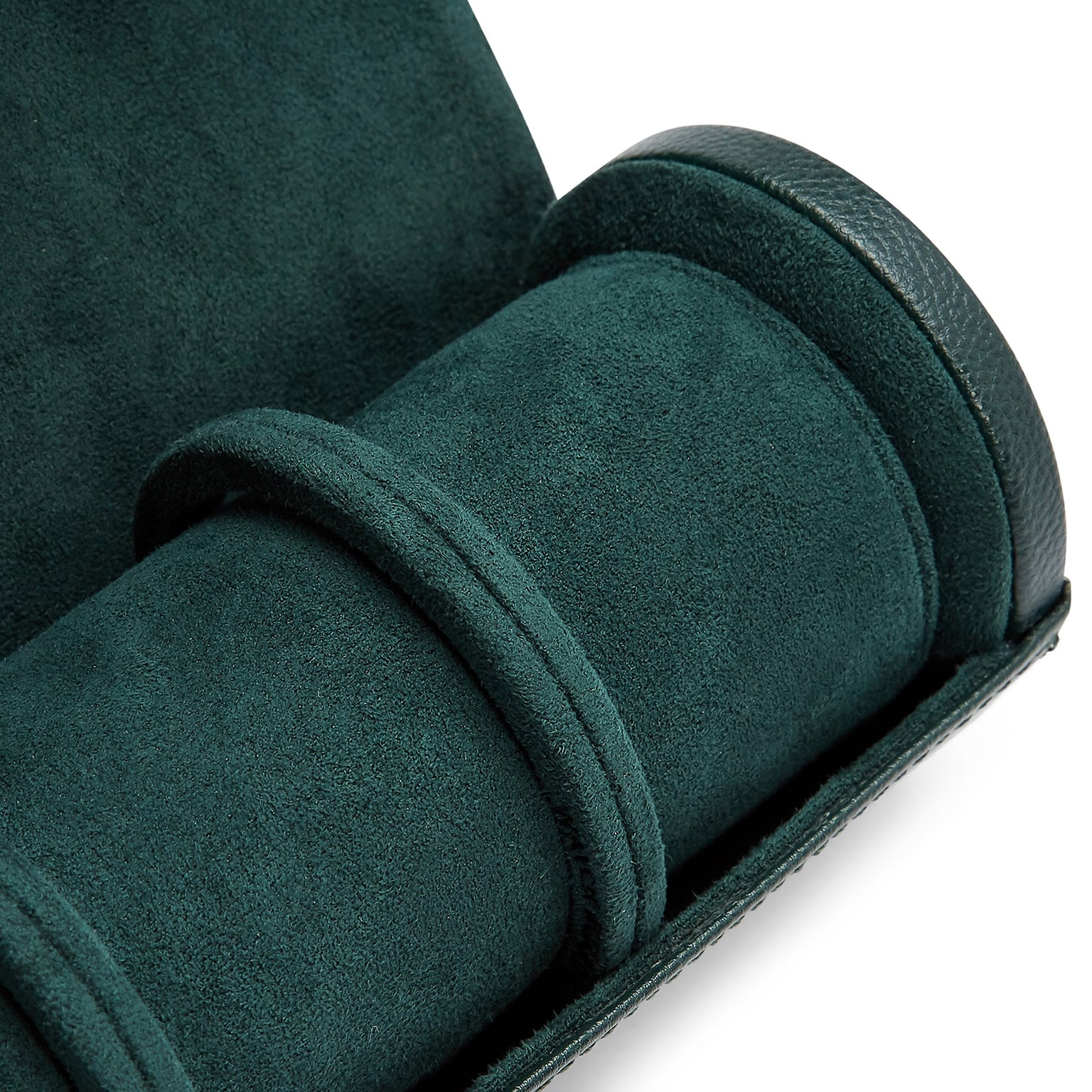The WOLF British Racing Triple Watch Roll in dark green suede features a cylindrical compartment with two dividers and is shown partially open.