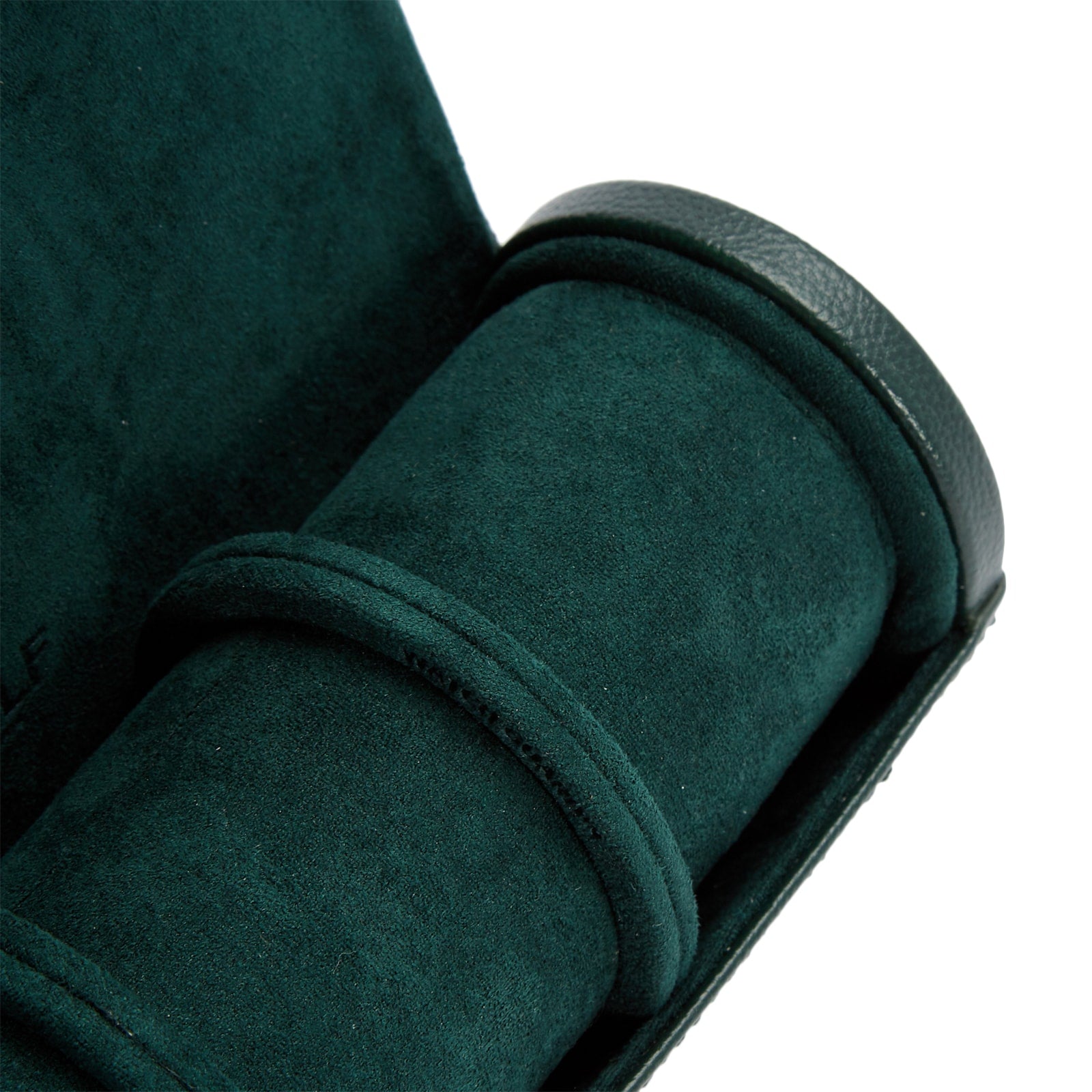 A close-up of the WOLF British Racing Triple Watch Roll in dark green suede, featuring a soft, cylindrical compartment.